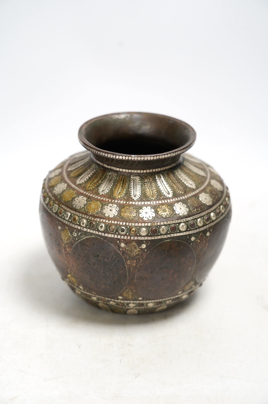 An Indian ganga jumna mixed metal water pot with engraved decoration, 14cm high. Condition - some dents